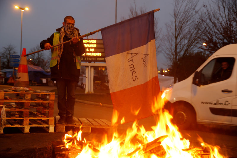France drops fuel tax hike as 'yellow vest' anger persists