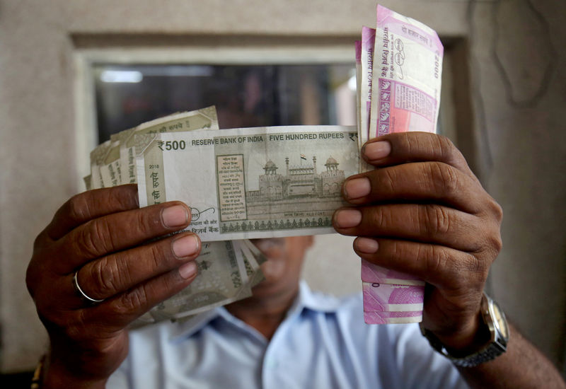 Indian rupee the 'whipping boy', but to dodge record low: Reuters poll