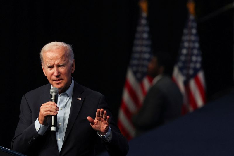 Biden warns on risk to democracy, Trump hints at another run on eve of midterms