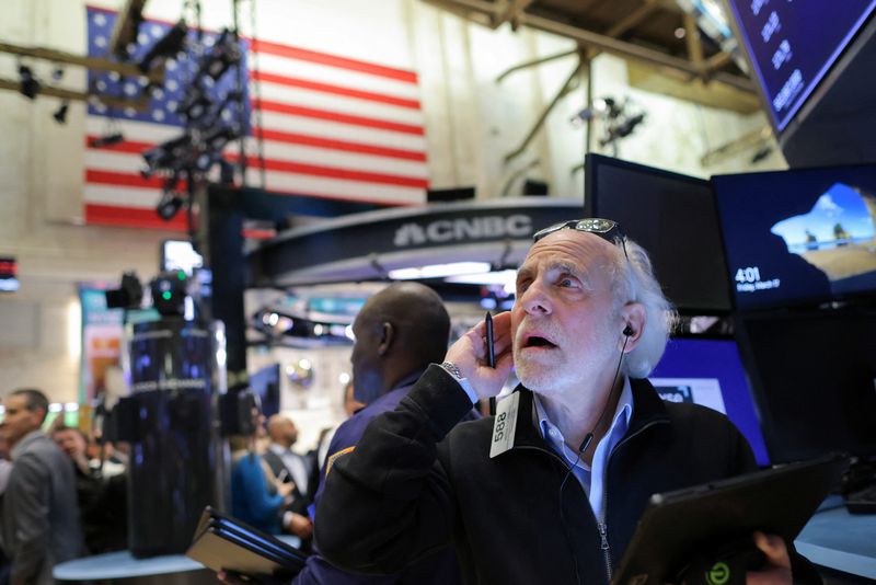 Wall St slips on mixed earnings, Fed's rate path in focus