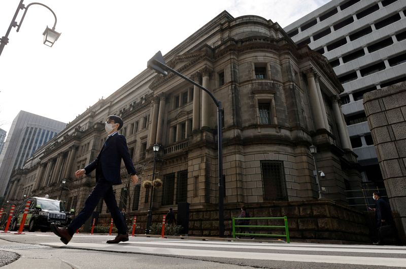 Japan's central bank will keep stimulus for now as risks grow